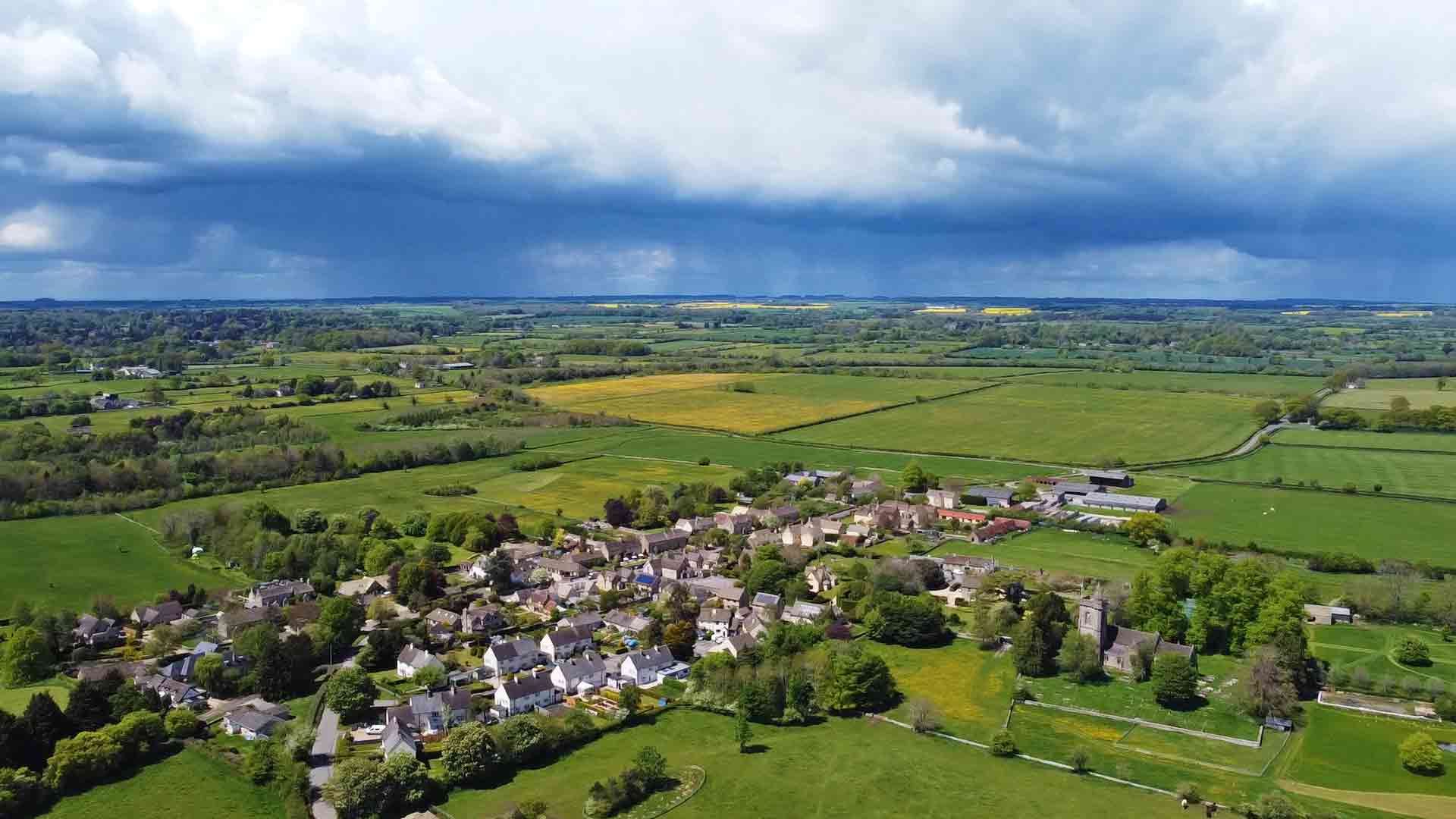 Rain Clouds Approaching A Cotswold Village